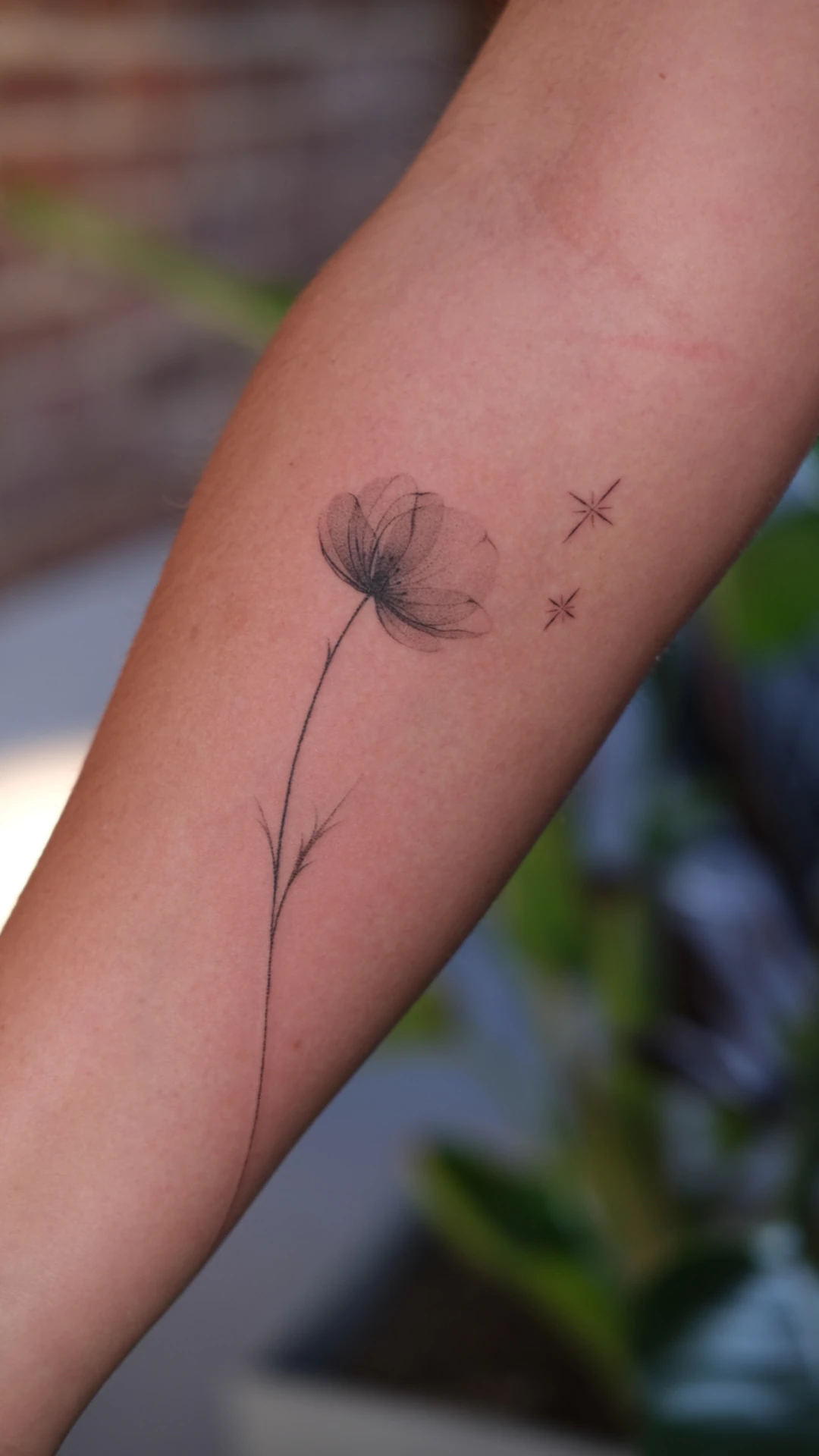 Floral handpoke tattoo by Maria Pokes in Lisbon